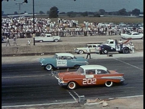 Various hot rods are driven, including a modified roadster, a Thunderbird, a Stock Footage 83227489