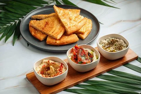 Various hummus set appetizer with flat bread Stock Photos