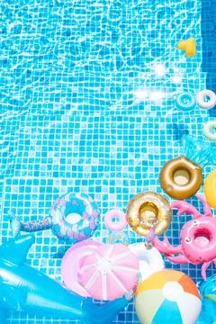 Various inflatable on a pool water background. ball, crab, dolphin, float. su Stock Photos