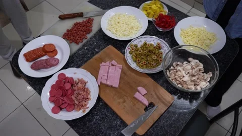 Various ingredients on the table to prepare homemade pizza in the kitchen Stock Footage 164579608