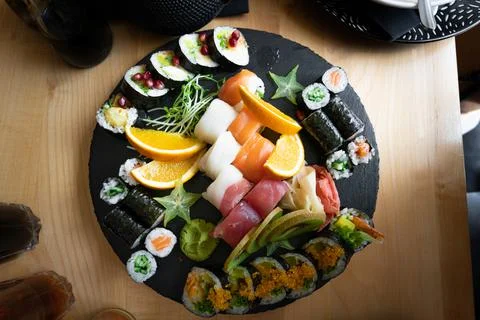 Various japenese sushi rolls on a slate plate Stock Photos
