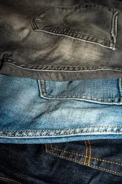 Various jeans back view. Old jeans of different colors Stock Photos