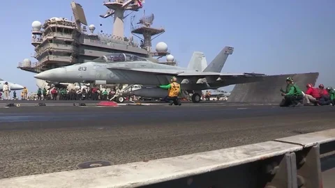 Various jet aircraft take off from the deck of an aircraft carrier. Stock Footage 74798198