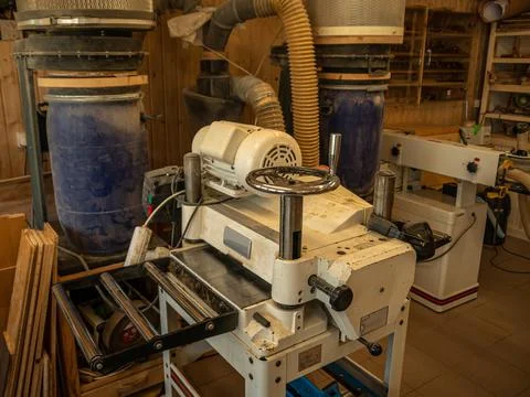 Various joinery machines for processing wood in a carpentry workshop. Stock Photos