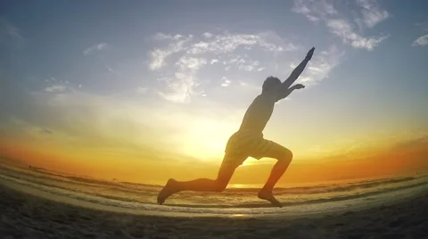 Various jumps while running on beach, sunset  스톡 동영상 56034066