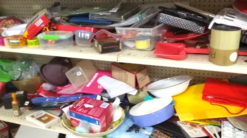 Various Junk Stacked on Retail Shelf - Goodwill Video stock 138178976