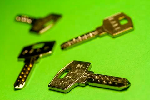 Various keys on green background Stock Photos