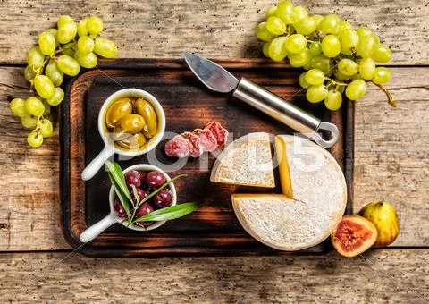 Various kind of cheese and delicacy on wood Stock Photos