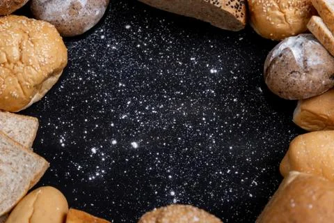 Various kinds of bread placed on the black wooden backgrounds Stock Photos