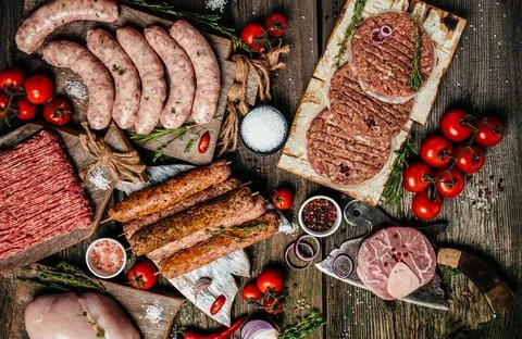 Various kinds of grill and bbq raw meats. Chicken, steak, sausages, minced .. Stock Photos