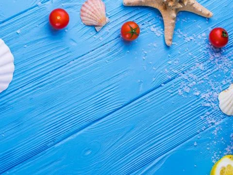Various kinds of sea shells frame on blue vintage shabby wood table. Summerti Stock Photos