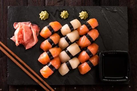 Various kinds of sushi served on a platter with soy sauce Stock Photos