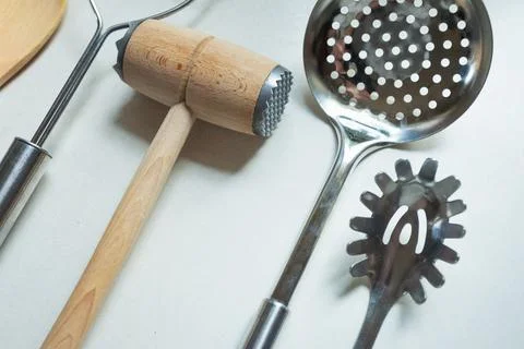 Various kitchen utensils on light background. Kitchen appliances, lay flat Stock Photos