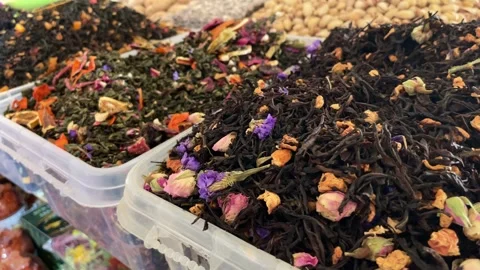 Various loose leaf tea blends with dried flowers displayed at a market Stock Footage 332692488