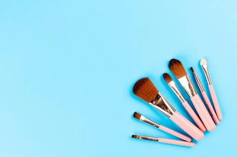 Various Makeup Brushes on blue Background Stock Photos