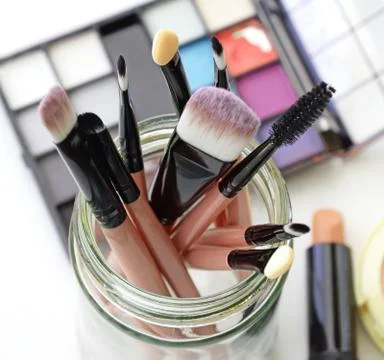 Various makeup brushes on light background Stock Photos