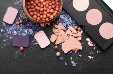 Various makeup products on dark background with copyspace Stock Photos