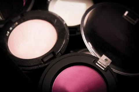 Various makeup shadows on dark background Stock Photos