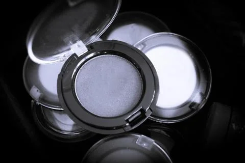 Various makeup shadows on dark background Stock Photos