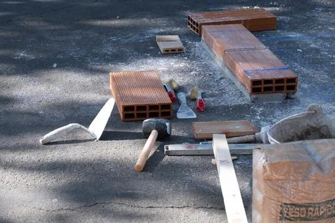 Various masonry and brickwork tools being used on a construction site Stock Photos