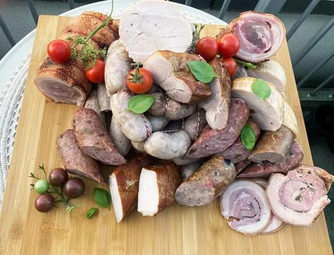 Various meat cold cut platter on a wooden board Stock Photos