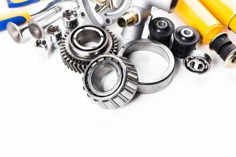 Various mechanical parts and tools for automotive repair displayed on a clean Stock Photos