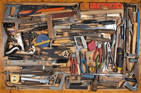 Various metalwork and carpentry tools, arranged on a wooden table. Foto stock