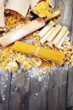 Various mix of pasta on grey rustic background. Diet and food concept. Stock Photos