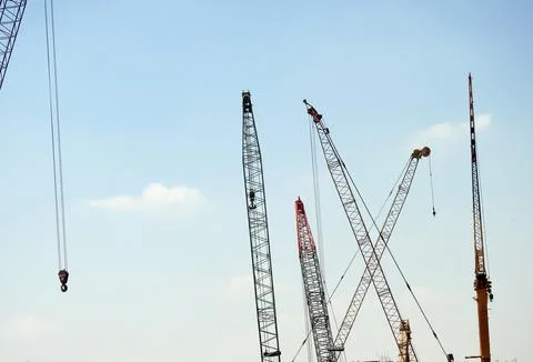 Various mobile wire cranes at a construction site at a factory that provides  Stock Photos