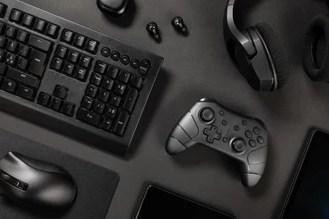 Various modern black wireless devices on desk Stock Photos