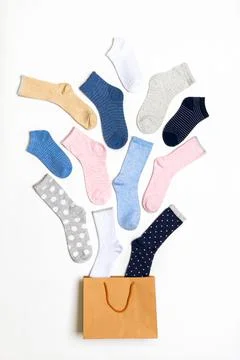 Various modern trendy women's cotton socks set in shopping bag on white backg Stock Photos