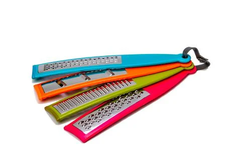Various multicolored vegetable graters on a white isolated background. Stockfoto's