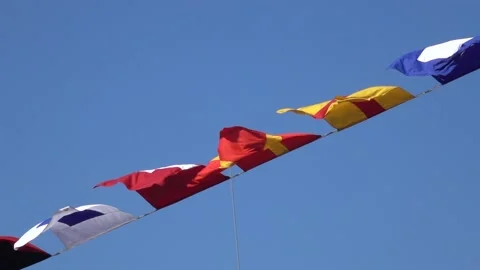 Various nautical flags tied together with rope, Ship flags signals, morse code, Stock-Footage 227493782