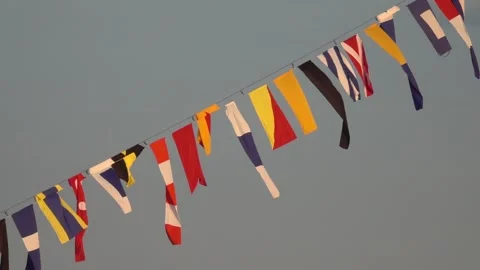 Various nautical flags tied together with rope, Ship flags signals, morse code, Video stock 281819497