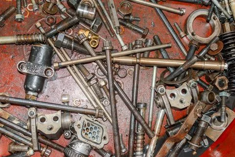Various nuts, bolts, and small engine parts. Stock Photos