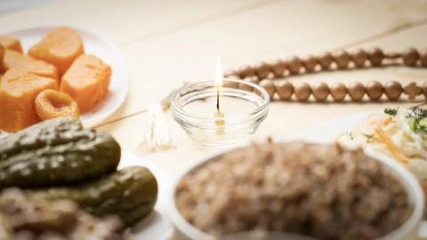 Various nuts in clay cup on table in front of Orthodox icon. Food for Christians Stock Photos