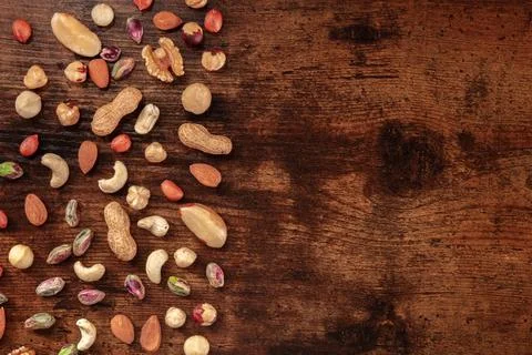 Various nuts, overhead flat lay shot on a dark rustic wooden background 写真素材