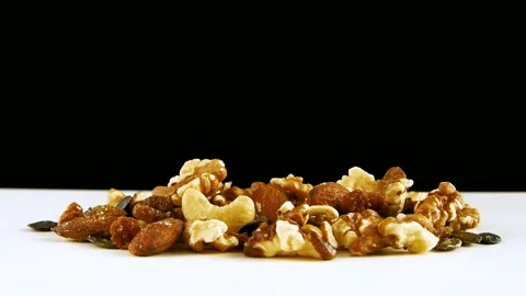 Various nuts on the white table against black background. Stock Footage 152352529