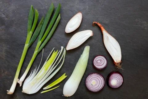 Various onions on slate Stock Photos