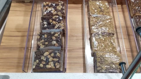 Various Packages of Brownies and Sweets Available for Purchase Grocery Store Stock Footage 137839563