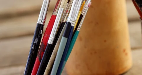 Various paintbrush in container Stock Footage