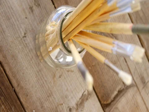 Various paintbrush in glass container Stock Footage
