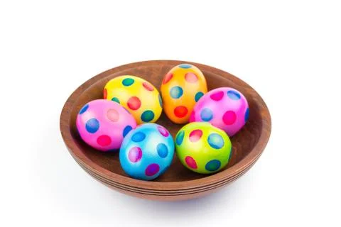 Various painted chicken easter eggs in wooden bowl on white Stock Photos