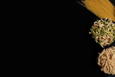 Various pasta. Cooking concept. Top view on dark beton background wuth copy s Stock Photos