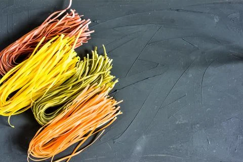 Various pasta over colored background. Top view with copy space Stock Photos