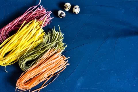 Various pasta over colored background. Top view with copy space Stock Photos