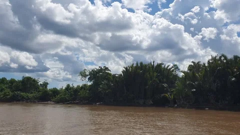 Various patterns of white clouds in the blue sky above the Kapuas River Видео 337222976