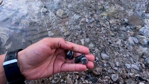 Various pebbles and hand Stock Footage 171856985