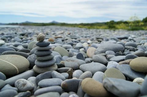 Various pebbles on the beach. Zen tower on a rocky beach Stock Photos