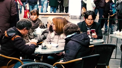 Various people sitting in a caffe inside Les Galeries Royales. Vidéo 152686466